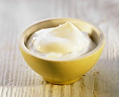 Yoghurt in a bowl on light background