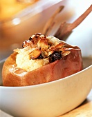 Baked apples with raisins and flaked almonds in a bowl