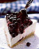 A piece of cheesecake with blueberries
