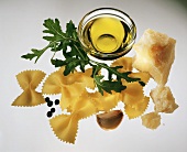 Farfalle pasta, olive oil in bowl, rocket, parmesan etc