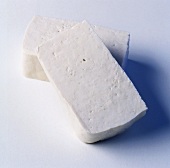 Two slices of tofu on light background