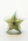 A carambola (star fruit) from above in soft lighting