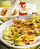 Rice noodles with omelette and cucumber salad on plate
