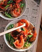 Prawns with vegetables & noodles on Chinese newspaper