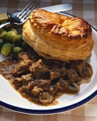 Beef stew with puff pastry and Brussels sprouts