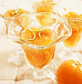 Orange dessert with lime zest in glass dishes