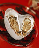 Oysters in a heart-shaped block of ice on a glass plate