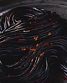 Black spaghetti with dried chili peppers