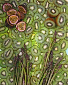 Granadilla halves and green asparagus on kiwi slices