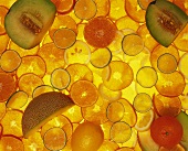 Slices of citrus fruits with wedges of musk melon
