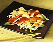 Duck breast with vegetables on Asian plate with chopsticks