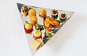 Assorted vegetarian snacks on aluminium tray