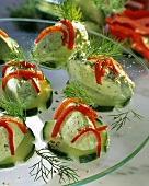 Herb mousse on cucumber slices with dill and pepper strips