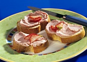 Three slices of white bread with strawberry butter