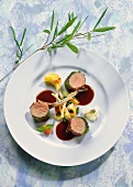 Saddle of lamb in herb crust with vegetables & garlic sauce