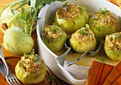 Kohlrabi with sausage stuffing on plate and in baking dish