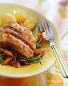 Saddle of lamb with rosemary on plate with fork