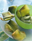 Artichokes with avocado dip in green bowl