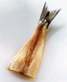 Young herring fillet with tail fin