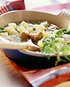 Vegetable stew with pork and peas in soup plate
