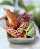 Crispy fried chicken wings with fresh basil