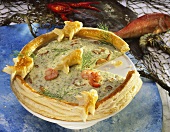 Fish tart with shrimps, decorated with puff pastry fish