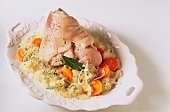 Surbratl (salted knuckle of pork) with sauerkraut on platter