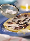 Blueberry pancake, sieve with icing sugar above it