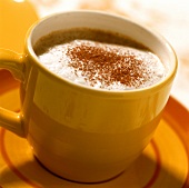 Children's cappuccino in a yellow cup