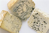 Three types of blue cheese on white background