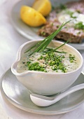Creamy chive sauce in a sauce boat