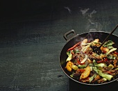 Steaming beef with sesame, fruit and vegetables in wok
