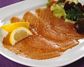 Smoked salmon slices with lemon slices & lettuce garnish