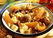 Fruit salad with figs, bananas, oranges and nuts