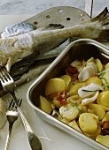 Pannfisch (fried fish) with potatoes in a roasting tin