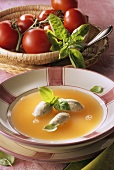 Clear tomato soup with dumplings and basil