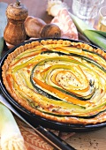 Leek quiche, topped with carrot and leek spirals