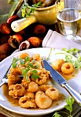 Deep-fried chicken breast with lychees on plate