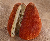 Boulette d'Avesnes, a cone-shaped cheese, on brown background
