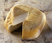 Niolo, a Corsican sheep's cheese, on reddish background