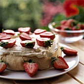 Whole strawberry meringue with cream on a plate