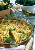 Hearty courgette & cheese quiche in a glass baking dish