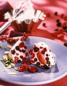Berry gugelhupf with pistachios on blue plate
