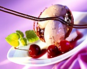 Bitter chocolate ice cream in a basket with cherries