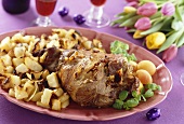 Leg of lam with roast potatoes and apricots