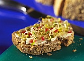Millet bread, topped with soft cheese and sprouts