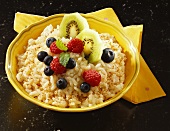 Rice pudding with berries and kiwi fruits