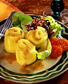Dumpling rolls with buttered breadcrumbs & lettuce on plate