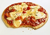 Pizza with tomatoes and cheese (bitten into)