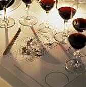 Half filled Bordeaux glasses around a map of Bordeaux